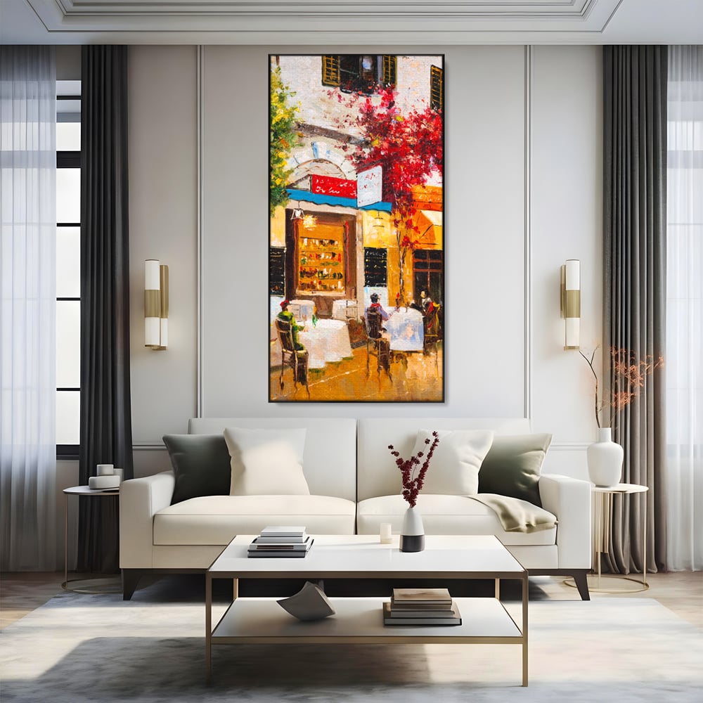 Tablou canvas cu pictura stradala cu terasa, in rama de aluminiu negru, pe perete intr-un living